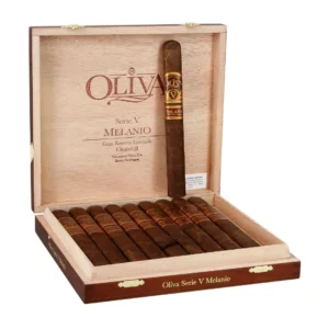 Open wooden cigar humidor with numerous Oliva Serie V Melanio cigars lined up inside; one cigar stands upright near the lid, with Oliva branding visible on the box edge and interior panel.
