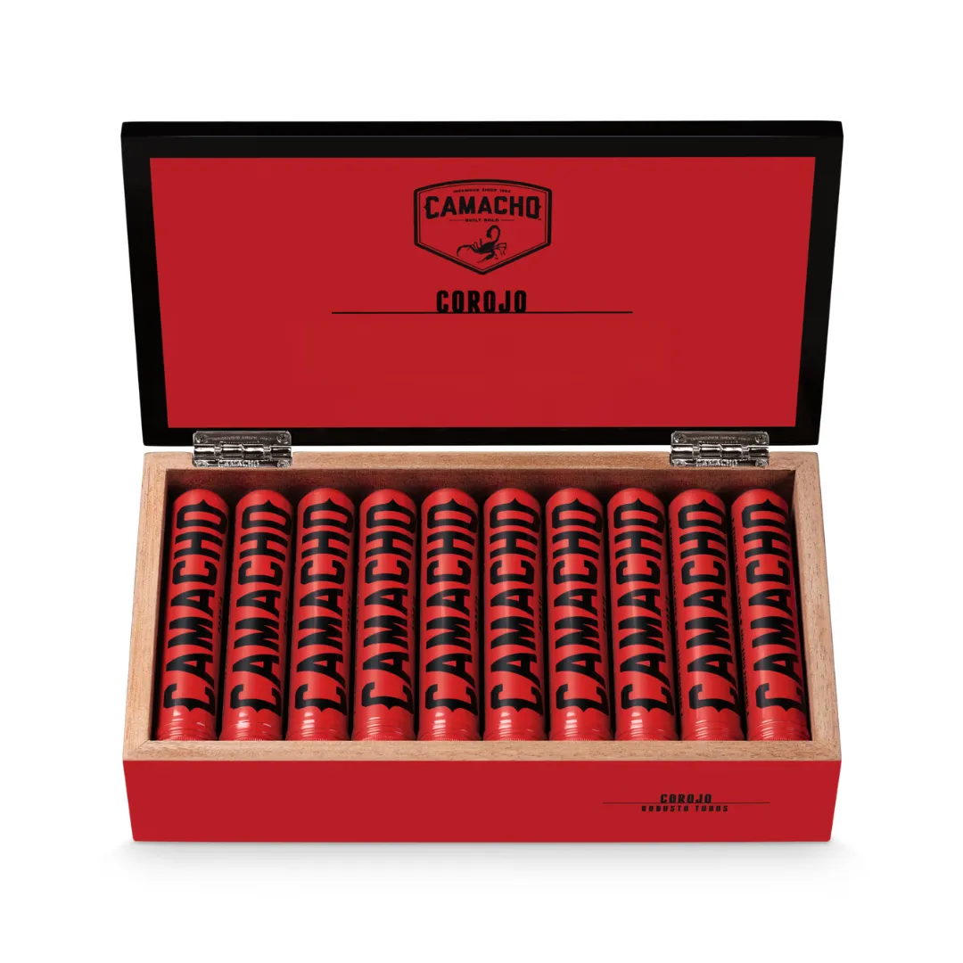 Open red Camacho Corojo cigar box with twelve red-wrapped cigars in a wooden tray inside a black-lidded case.