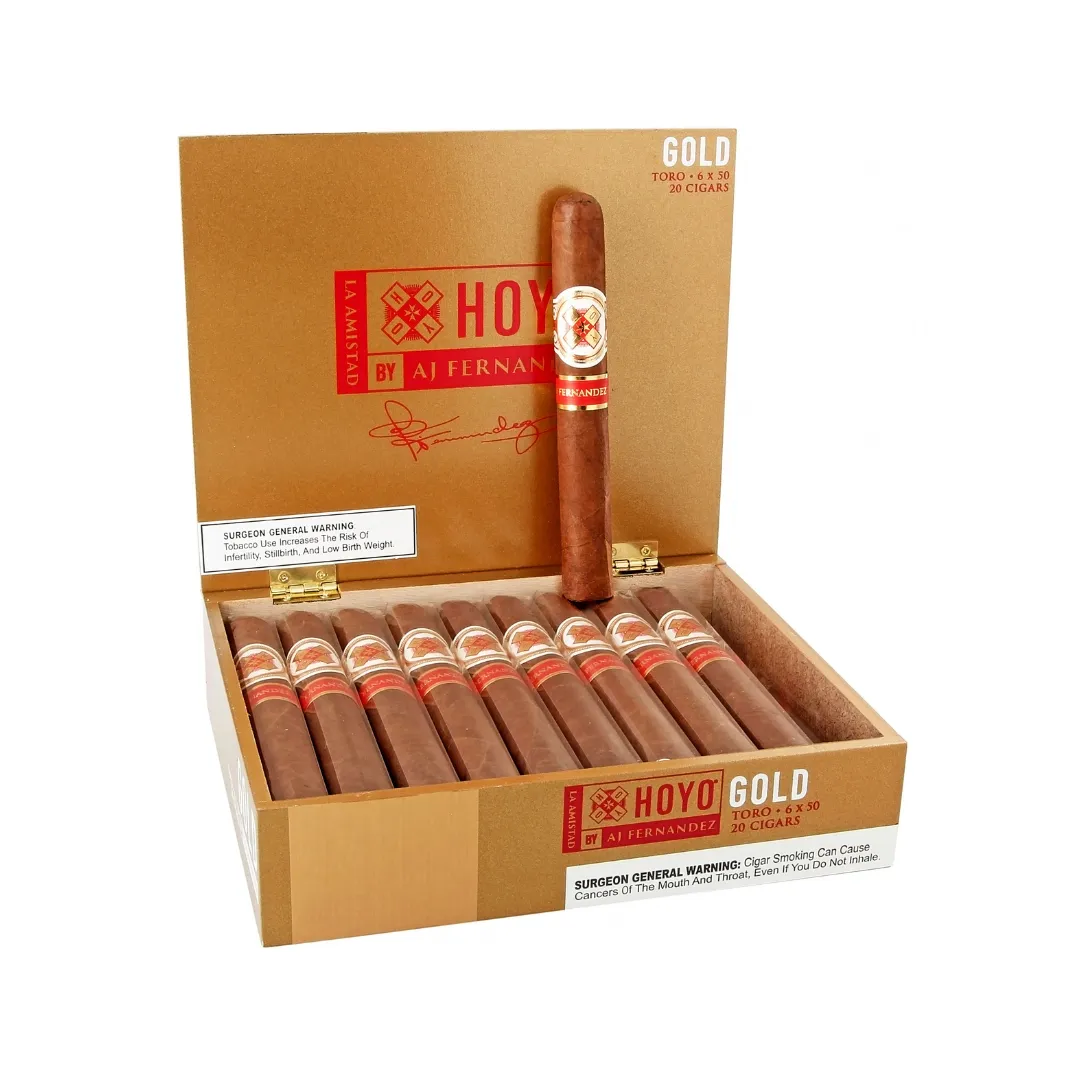 Open cigar box with 20 brown cigars, label HOYO Gold by AJ Fernandez, one cigar standing upright inside lid.
